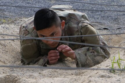 Spc. Michael Choi navigates the Air Assault Obstacle Course May 12, 2021, during the Region II Best Warrior Competition at Fort Indiantown Gap, Pennsylvania.