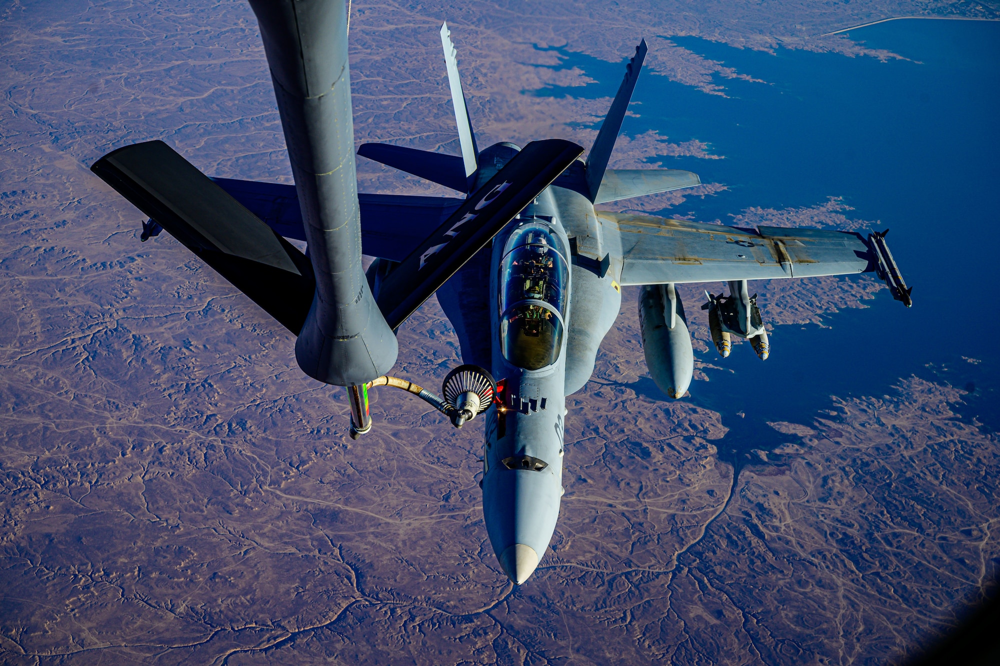 A U.S. Marine Corps F/A-18D Hornet aircraft from Marine All Weather Attack Squadron 224, Marine Aircraft Group 31, approaches the refueling boom of a U.S. Air Force KC-135 Stratotanker aircraft during a mission supporting a dynamic force employment over the U.S. Central Command area of responsibility, May 18, 2021. Dynamic operations and force employment in the theater highlight the U.S. military’s ability to deploy and employ forces anywhere around the globe. (U.S. Air Force photo by Tech. Sgt. Robert Harnden)