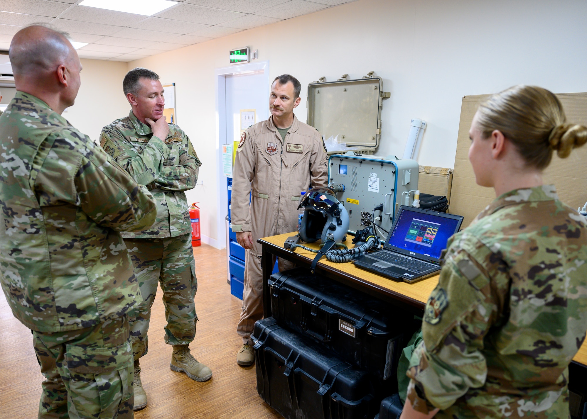 Brig. Gen. Evan Pettus, 378th Air Expeditionary Wing commander, briefs Maj. Gen. Wendul Hagler, Senior Defense Official and Defense Attaché at the Embassy of the United States, Kingdom of Saudi Arabia, about the aircrew flight equipment flight during his visit to Prince Sultan Air Base, KSA, May 26, 2021. Several U.S. generals from across the region and their staff visited units at PSAB, meeting with various personnel to learn about defense efforts and expanding capabilities on base. (U.S. Air Force photo by Senior Airman Samuel Earick)