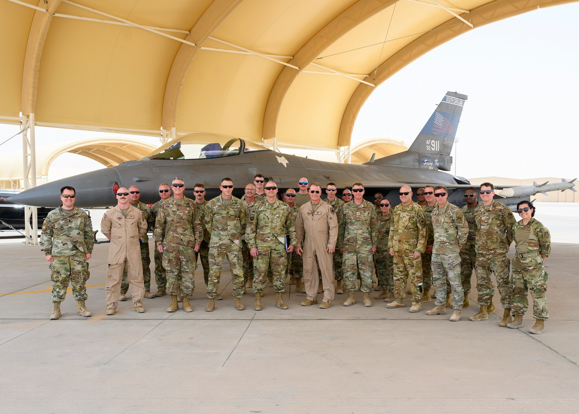 Maj. Gen David Meyer, 9th Air Force (Air Forces Central) deputy commander and and Deputy Combined Force Air Component Commander, and Maj. Gen. Wendul G. Hagler II, Senior Defense Official and Defense Attaché at the Embassy of the United States, Kingdom of Saudi Arabia, pose for a picture with base leaders and members of South Carolina Air National Guard’s 169th Fighter Wing who are currently assigned to the 378th Expeditionary Operations Group, Prince Sultan Air Base, KSA, May 26, 2021. Meyer, who previously served as the 169th FW commander, was joined by several U.S. generals and their staff to visit PSAB, meeting with various personnel to learn about defense efforts and expanding capabilities on base. (U.S. Air Force photo by Senior Airman Samuel Earick)
