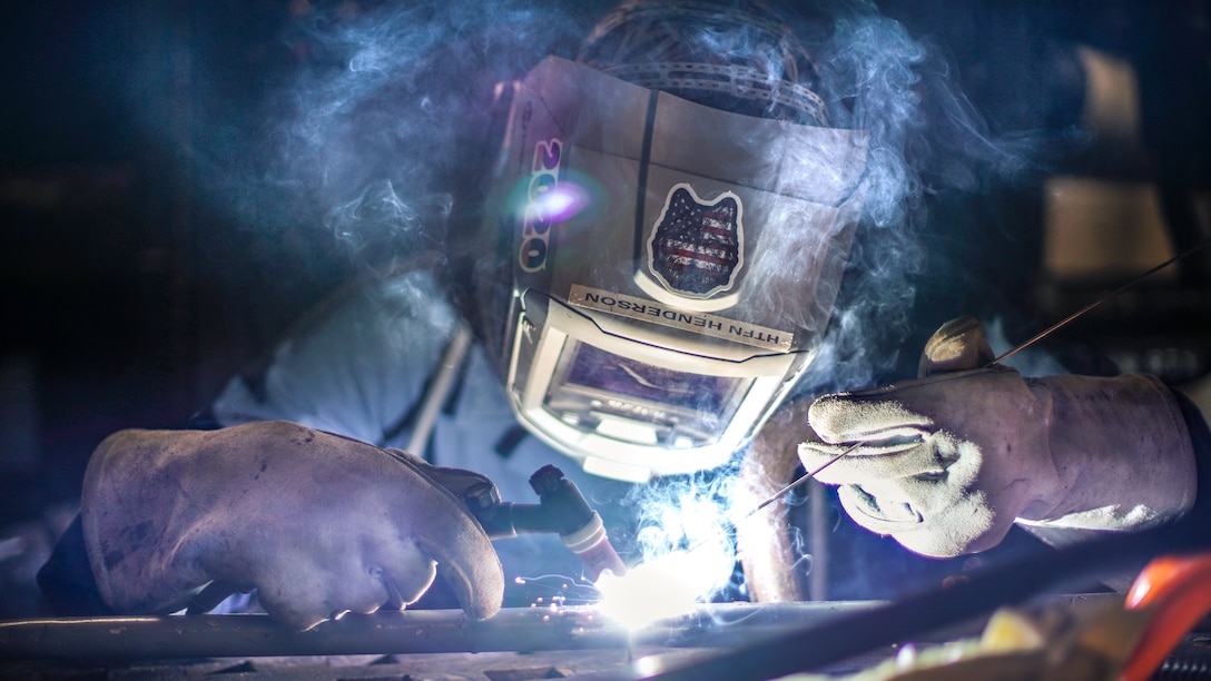 U.S. Navy Hull Maintenance Technician Fireman Gage Foreman, with Assault Craft Unit 5, welds a handrail for a CH-53E Super Stallion aboard amphibious transport dock USS Portland, April 22, 2021. Sailors and Marines of the Essex Amphibious Ready Group and the 11th Marine Expeditionary Unit are underway conducting integrated training off the coast of southern California.