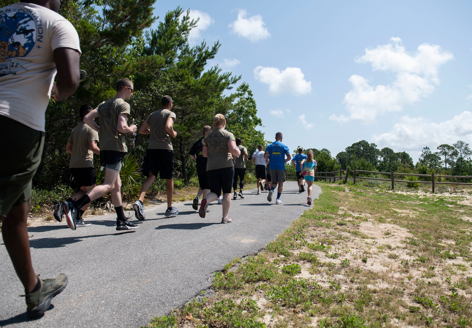 Airmen running on a trail.