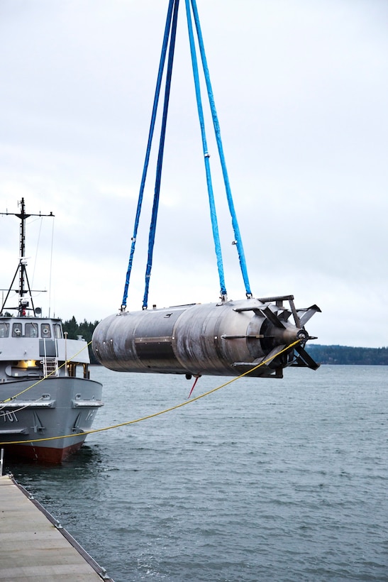 A surrogate Large Displacement Unmanned Undersea Vehicle (LDUUV) is submerged in the water in preparation for a test at the Naval Undersea Warfare Center Division Keyport in Puget Sound, Wash., in December 2015.