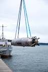A surrogate Large Displacement Unmanned Undersea Vehicle (LDUUV) is submerged in the water in preparation for a test at the Naval Undersea Warfare Center Division Keyport in Puget Sound, Wash., in December 2015.