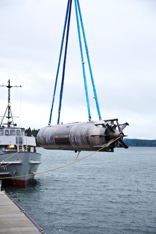 A surrogate Large Displacement Unmanned Undersea Vehicle (LDUUV) is submerged in the water in preparation for a test at the Naval Undersea Warfare Center Division Keyport in Puget Sound, Wash., in December 2015.