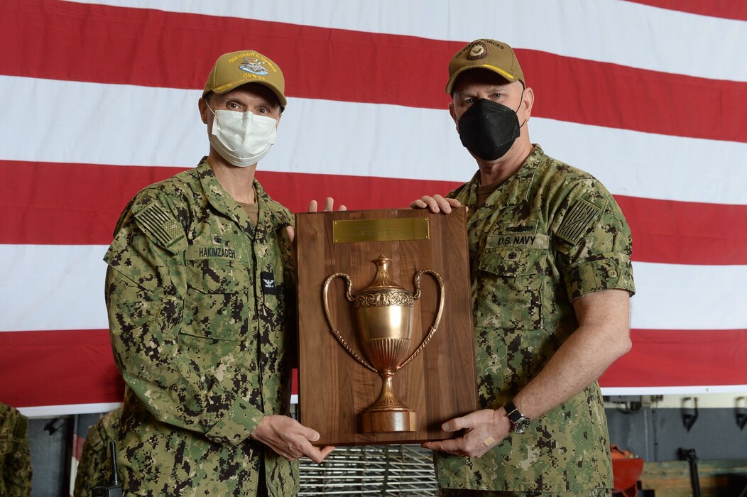 Kavon Hakimzadeh, commanding officer of the Nimitz-class aircraft carrier USS Harry S. Truman (CVN 75), receives the 2020 Battenberg Plaque from Adm. Christopher Grady, commander, U.S. Fleet Forces Command, The Battenberg Cup is awarded annually to the ship that best exemplifies operational excellence.