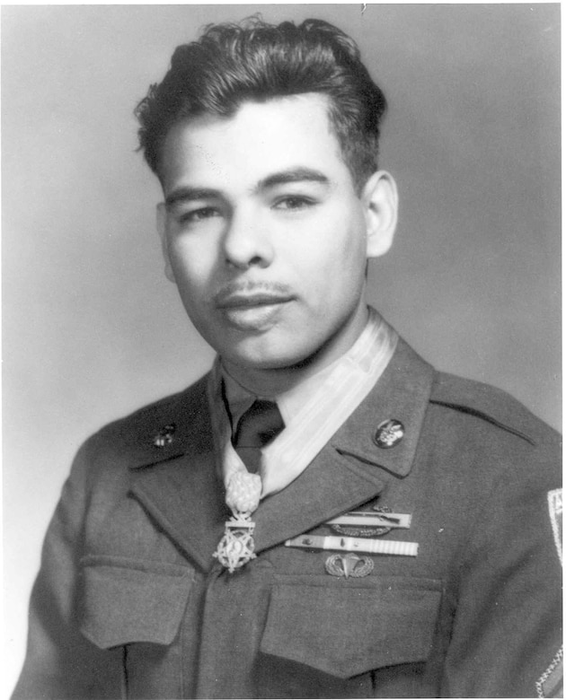 A man in uniform wears a medal around his neck.