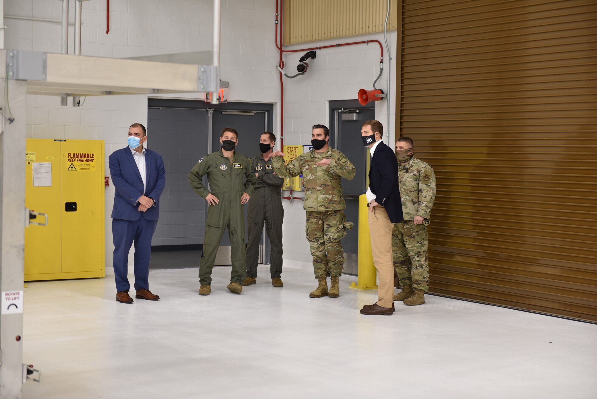 Chief Master Sgt. Benjamin Waxenfelter, the 911th Aircraft Maintenance Squadron superintendent (left of Lamb), briefs U.S. State Rep. Conor Lamb, Pennsylvania's 17th District, about the capabilities the two-bay C-17 Globemaster III hangar provides to the maintenance squadron at the Pittsburgh International Airport Air Reserve Station, Pennsylvania, April. 26, 2021.