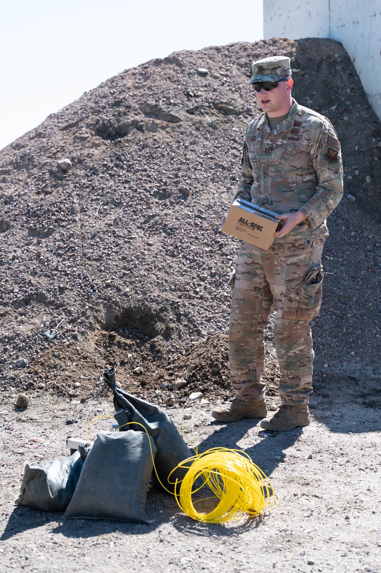 Capt. William Knox, 341st Civil Engineer Squadron explosive ordnance disposal flight commander, explains how a remote-fired shotgun fired a hole through a cardboard box during a training demonstration June 2, 2021, at Malmstrom Air Force Base, Mont.