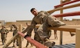 U.S. Army Soldiers from 36th Infantry Division Higher Headquarters Battalion, 111th Theater Engineer Brigade, 130th Field Artillery Brigade, Task Force Hellhound, Task Force Avalanche, and Task Force Bastards participate in the obstacle course portion of the TF Spartan Best Warrior Competition, May 28, 2021, at Camp Buehring, Kuwait. The course consisted of seven obstacles, to include the Tough One, the Weaver, Inclined Wall, Belly Crawl, Six Vaults, Low Belly Over, and High Knees, that the participants had to complete within time constraints to gain enough points to pull ahead of the other competitors. The Soldiers took part in TF Spartan BWC to determine who would be the “Best Warrior” to move on to U.S. Army Central Command’s competition in June 2021.  (U.S. Army photo by Staff Sgt. Daryl Bradford, TF Spartan Public Affairs)