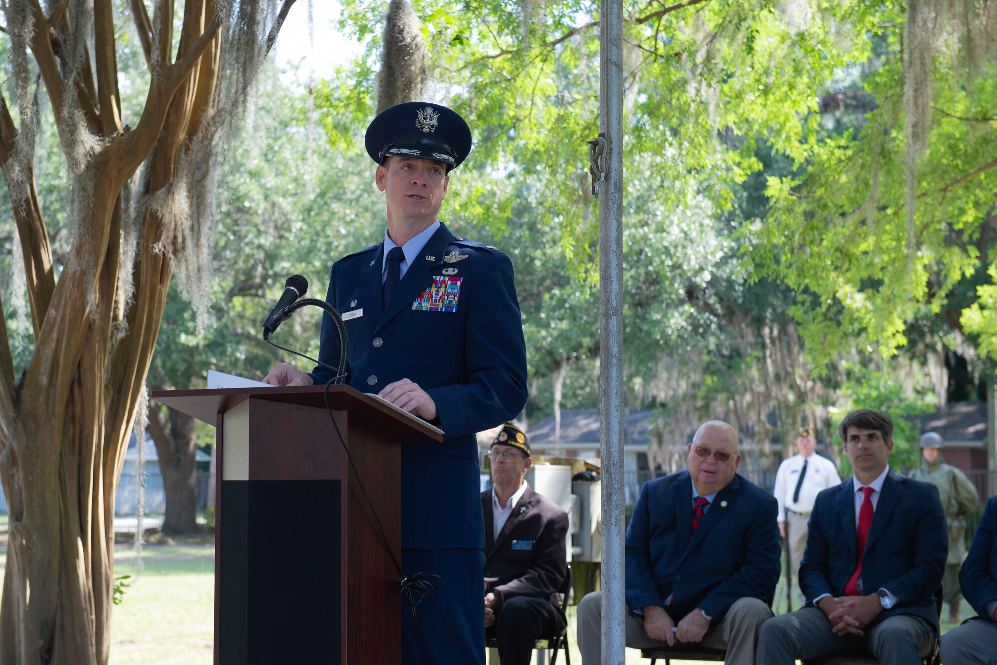 A photo of the 23d Wing commander speaking at a podium