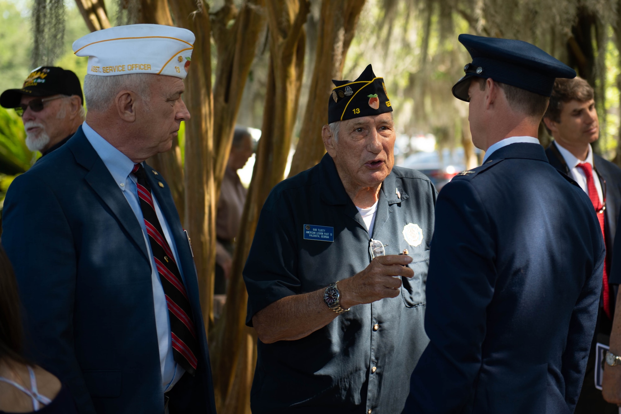 A photo of an Airman speaking to veterans.