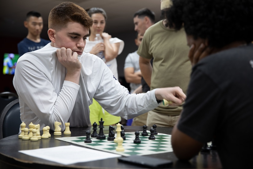 U.S. Army Spc. Juan Perez, a medical logistics specialist with the 393rd Medical Logistics Company, captures an opponent's pawn during the Morale, Welfare and Recreation’s Chess Tournament at the MWR Community Center at Camp Arifjan, Kuwait, May 23, 2021. Perez defeated his opponent to advance to the quarterfinals. (U.S. Army photo by Spc. Elizabeth Hackbarth, U.S. Army Central Public Affairs)