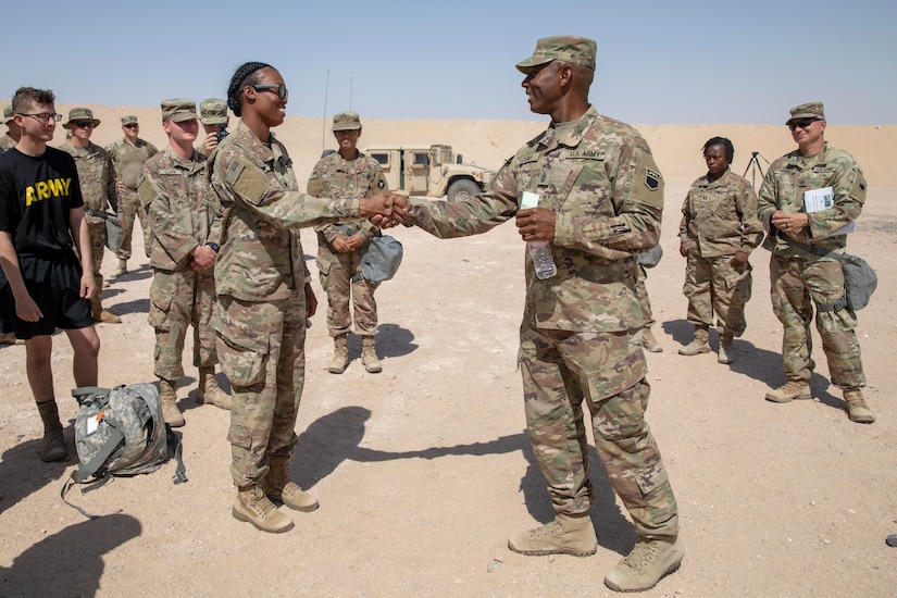 U.S. Army 1st Sgt. Tony Perry (right), the first sergeant of the 318th Chemical, Biological, Radiological, Nuclear Company, recognizes U.S. Army Spc. Hope Brown, a CBRN specialist with the 318th CBRN Company, for her planning and coordination of the CBRN training at Camp Buehring, Kuwait, May 27, 2021. Brown acted as noncommissioned officer in charge despite her rank, organizing the decontamination line and equipment confidence training. (U.S. Army photo by Spc. Maximilian Huth)