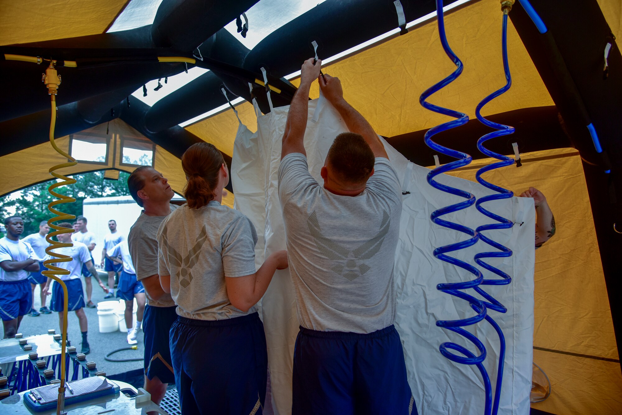 Airmen set up a tent during medical training.