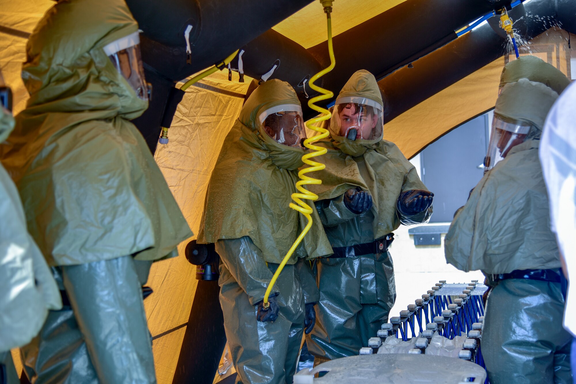 Medics wear protective gear during patient decontamination training
