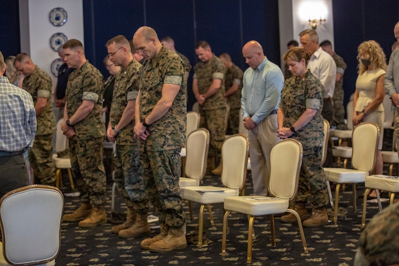 Service members and civilians bow their heads during the invocation at the activation ceremony of 2nd Network Battalion on Marine Corps Base Camp Lejeune, North Carolina, June 3, 2021. 2nd Network Battalion was activated to ensure the operation of a resilient network that enables mission execution in the face of persistent cyber threats. (U.S. Marine Corps photo by Lance Cpl. Isaiah Gomez)