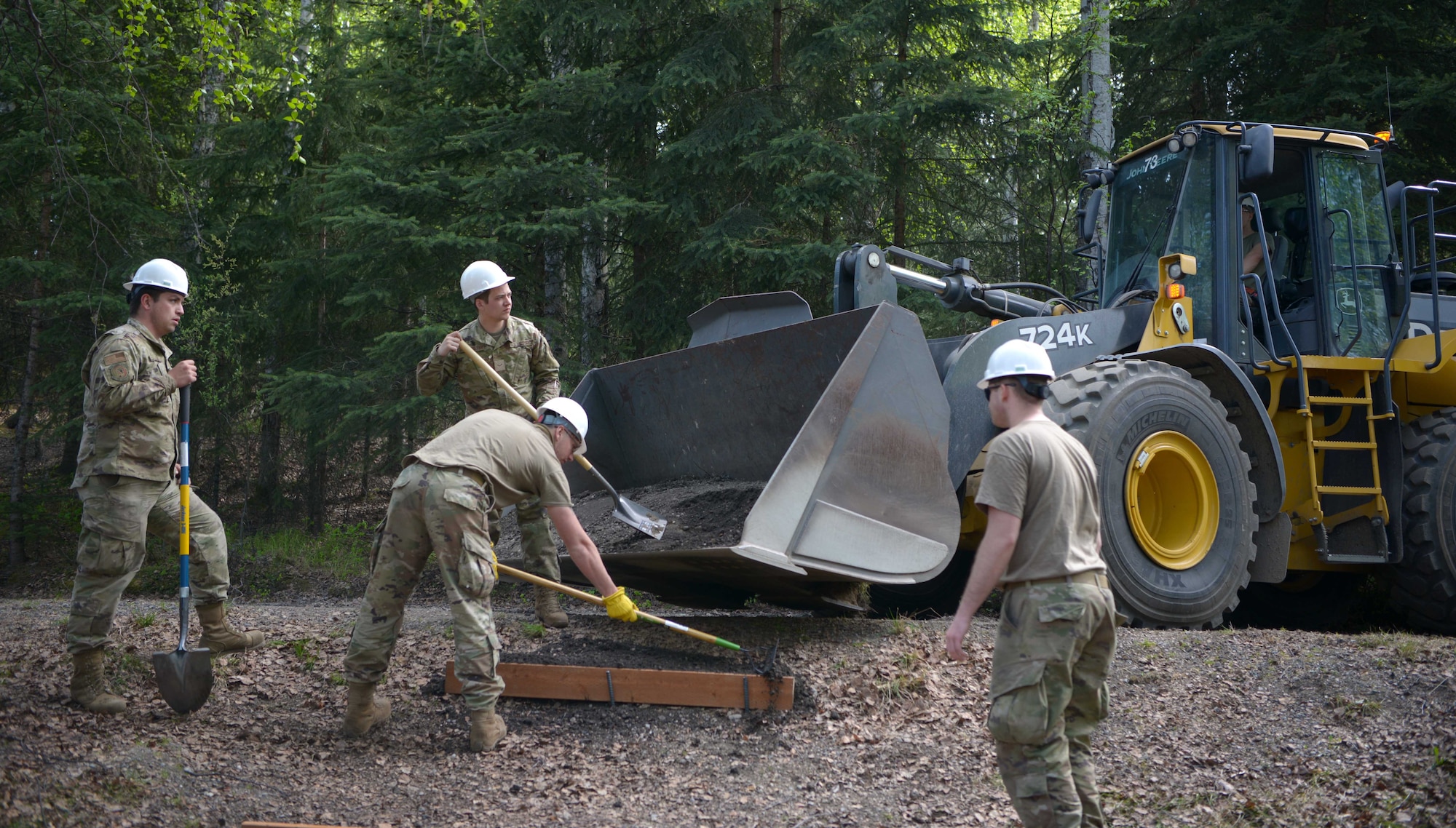 U.S. Air Force Airmen assigned to the 354th Civil Engineer Squadron construct steps during a troop training project May 26, 2021, at the Birch Lake Military Recreation Area, Alaska. To give the troops a sense of competition, the squadron encouraged the teams to complete one small personal renovation in addition to their assigned projects. Most teams built a bench by the cabin they renovated, while others took a different approach such as adding gravel steps to make it easier for people to traverse the campgrounds. (U.S. Air Force photo by Senior Airman Beaux Hebert)