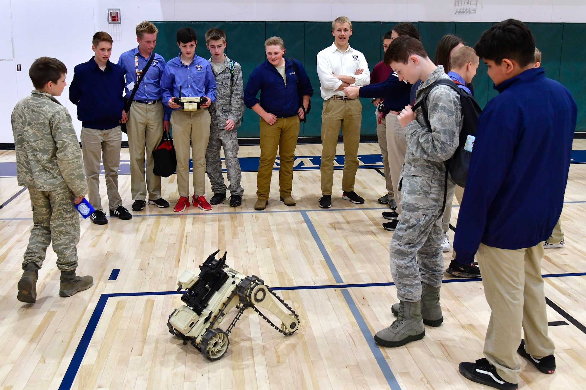 Students at the Utah Military Academy take turns driving a Micro Tactical Ground Robot at the explosive ordnance disposal display during a job fair May 25, 2021, in Riverdale, Utah. Airmen from Hill Air Force Base recently hosted the event at the nearby charter high school to educate and inspire students, as well as promote interest in the possibility of future military careers. (U.S. Air Force photo by Todd Cromar)