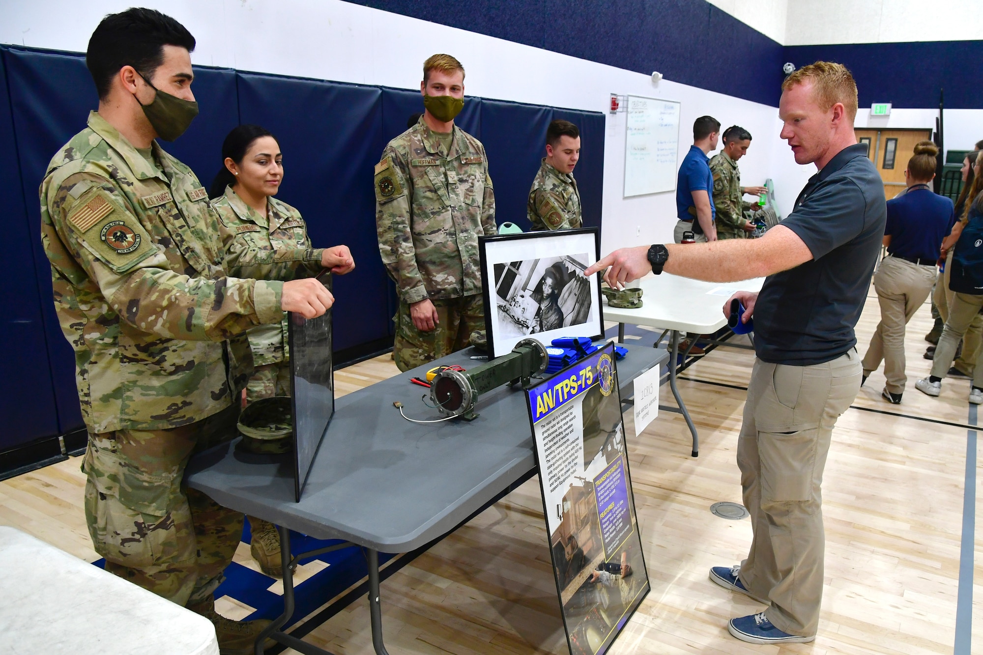 Airman First Class Gonzalez Ramirez Omar, 729th Air Control Squadron, speaks with a student while participating in a job fair at the Utah Military Academy, May 25, 2021, in Riverdale Utah. Airmen from Hill Air Force Base recently hosted the event at the nearby charter high school to educate and inspire students, as well as promote interest in the possibility of future military careers. (U.S. Air Force photo by Todd Cromar)
