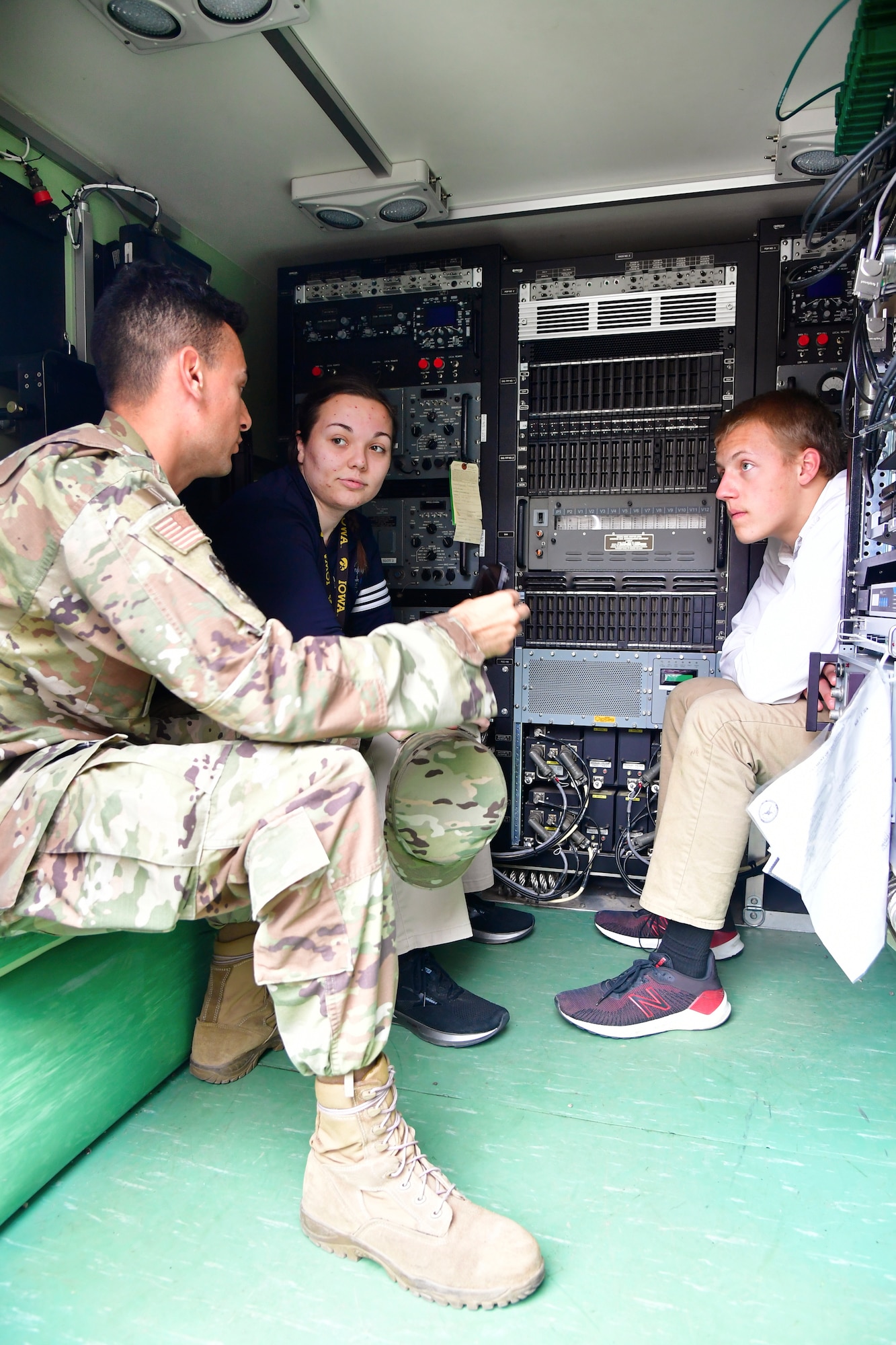 Staff Sgt. Matthew Romero, 729th Air Control Squadron, discusses mobile communications equipment with students during a job fair at the Utah Military Academy, May 25, 2021, in Riverdale, Utah. Airmen from Hill Air Force Base recently hosted the event at the nearby charter high school to educate and inspire students, as well as promote interest in the possibility of future military careers. (U.S. Air Force photo by Todd Cromar)