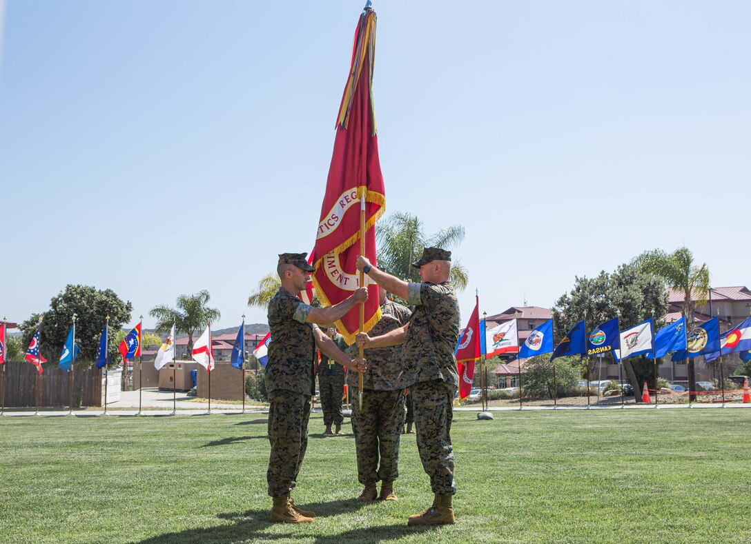 U.S. Marine Corps Col. Michael W. Stehle, outgoing commanding officer, right, Combat Logistics Regiment 1, 1st Marine Logistics Group, and incoming commanding officer Col. Ryan E. Scott, left, exchange the Regimental colors during the CLR-1 change of command ceremony,