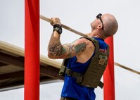 U.S. Marine Corps Gunnery Sgt. Eric Jude, the IMA maintenance chief with  Headquarters & Headquarters Squadron (H&HS), Marine Corps Air Station (MCAS) Yuma, performs pullups as a part of a squadron MURPH challenge on MCAS Yuma, Ariz., May 26, 2021. The MURPH is a workout challenge consisting of a 1 mile run, 100 pullups, 200 pushups, 300 squats, followed by another 1 mile run. The workout was a favorite of Lt. Michael P. Murphy, a Navy Seal who lost his life in Afghanistan. (U.S. Marine Corps Photo by Cpl. Joseph Exner)