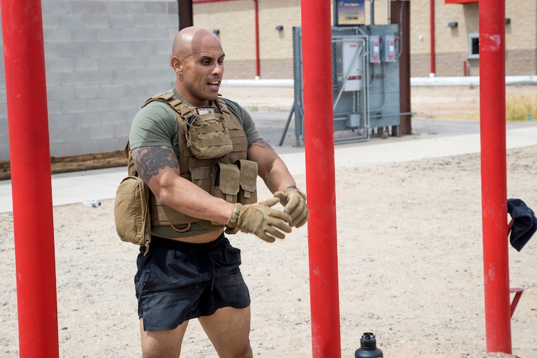 U.S. Marine Corps Sgt. Maj. Luis A. Galvez, the SgtMaj. for Headquarters & Headquarters Squadron (H&HS), Marine Corps Air Station (MCAS) Yuma, performs squats as a part of a squadron MURPH challenge on MCAS Yuma, Ariz., May 26, 2021. The MURPH is a workout challenge consisting of a 1 mile run, 100 pullups, 200 pushups, 300 squats, followed by another 1 mile run. The workout was a favorite of Lt. Michael P. Murphy, a Navy Seal who lost his life in Afghanistan.(U.S. Marine Corps Photo by Cpl. Joseph Exner)