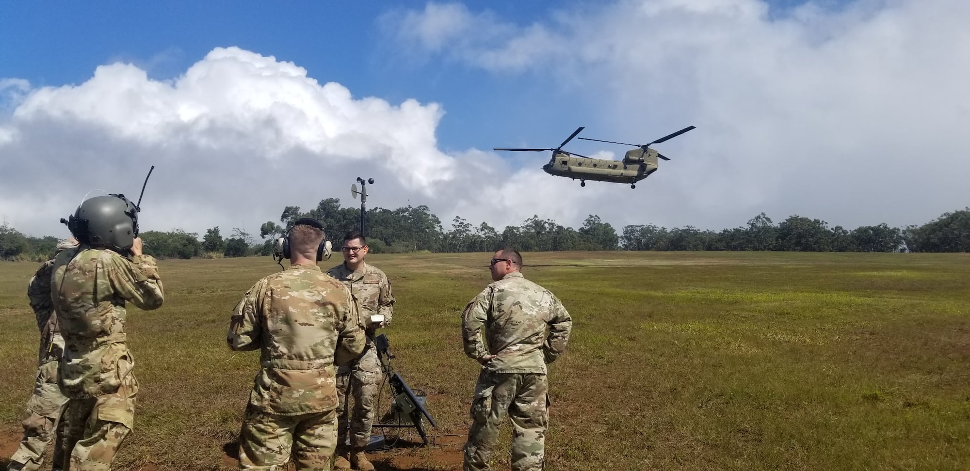 An Airman from Detachment 2, 1st Combat Weather Squadron, Wheeler Army Airfield measuring the rotor wash wind speed of a CH-47 Chinook for future tactical operations. (Courtesy Photo)