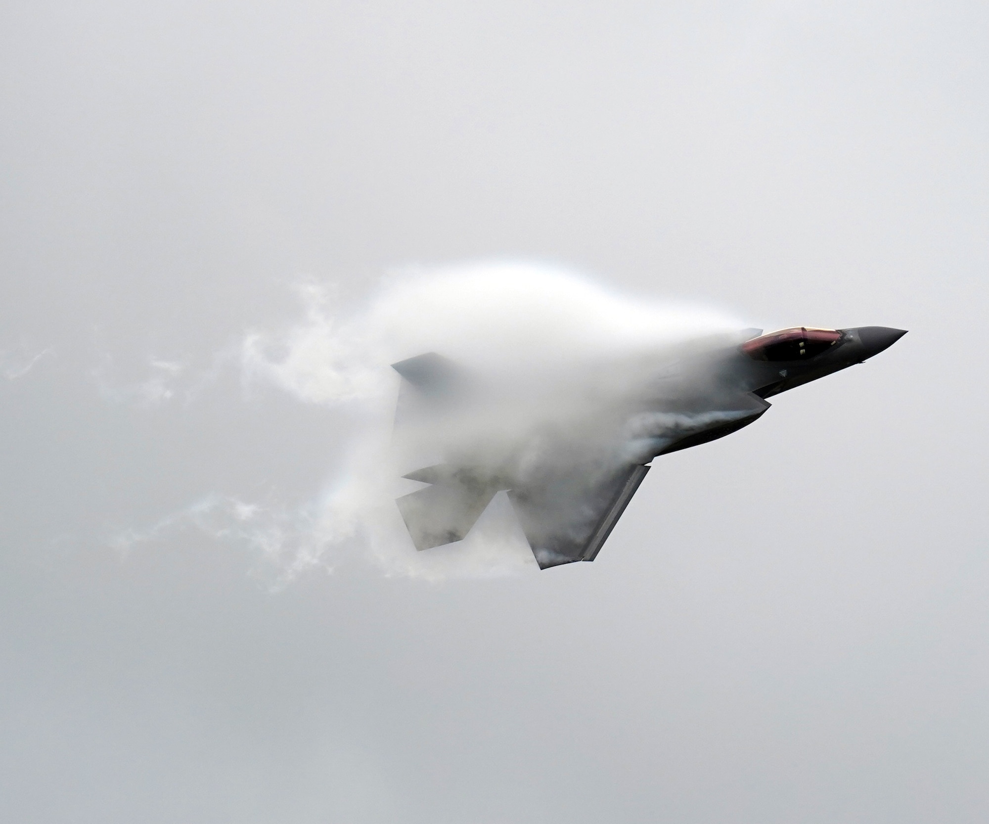 airplane flying through vapor cloud