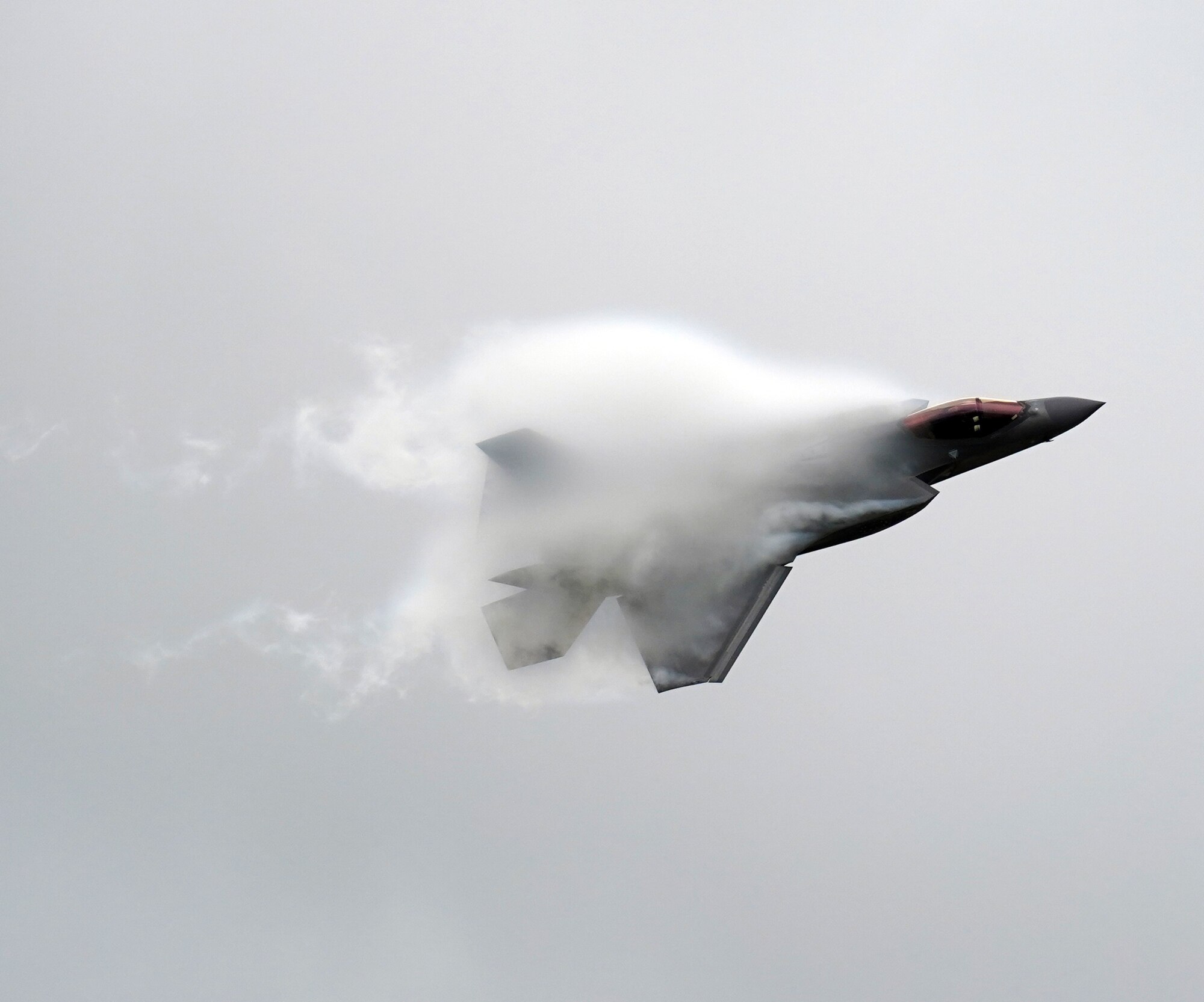 airplane flying through vapor cloud