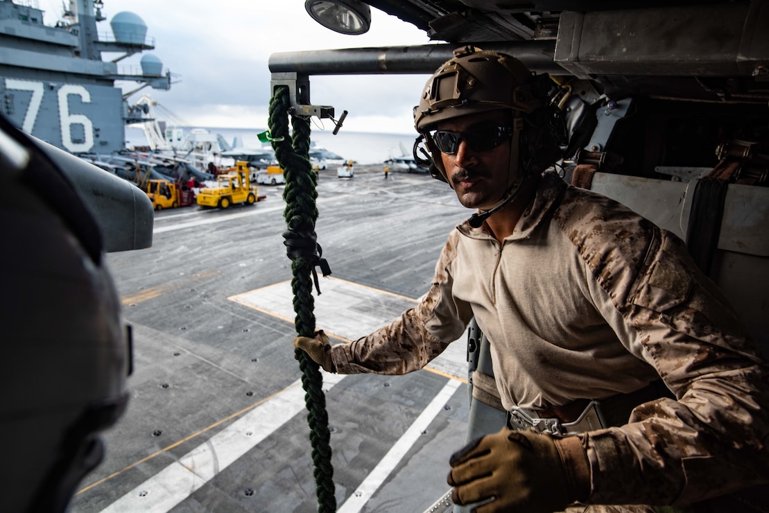 Explosive Ordnance Disposal 3rd Class Ajith Brown prepares to conduct fast-rope training from an MH-60S Sea Hawk onto the aircraft carrier USS Ronald Reagan (CVN 76).