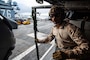 Explosive Ordnance Disposal 3rd Class Ajith Brown prepares to conduct fast-rope training from an MH-60S Sea Hawk onto the aircraft carrier USS Ronald Reagan (CVN 76).