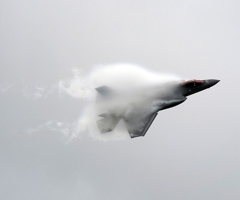 airplane flying through vapor cloud