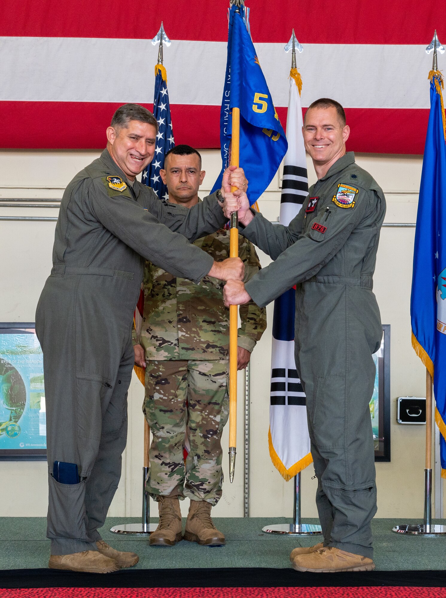 U.S. Air Force Col. John Gonzales, 51st Fighter Wing commander, left, passes the 5th Reconnaissance Squadron guidon to Lt. Col. Michael Opresko, incoming 5th RS commander, right, during the 5th RS change of command at Osan Air Base, Republic of Korea, June 4, 2021. Opresko assumed command of a large squadron of 220+ Airmen with responsibilities encompassing operations, maintenance and support functions responsible for all U-2 Dragon Lady high altitude reconnaissance in the Pacific theater of operations. (U.S. Air Force photo by Senior Airman Branden Rae)