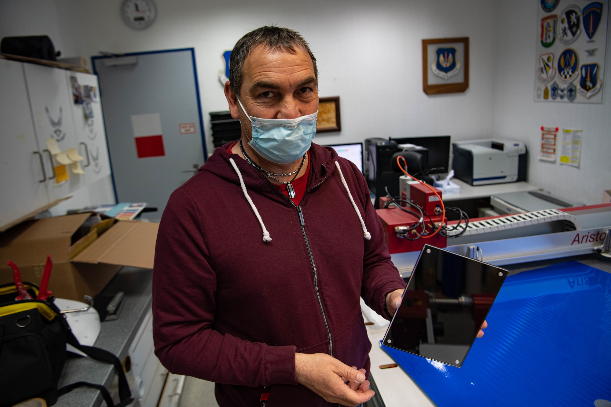 Michael Heinz holds the material that he used to create three awards boards.