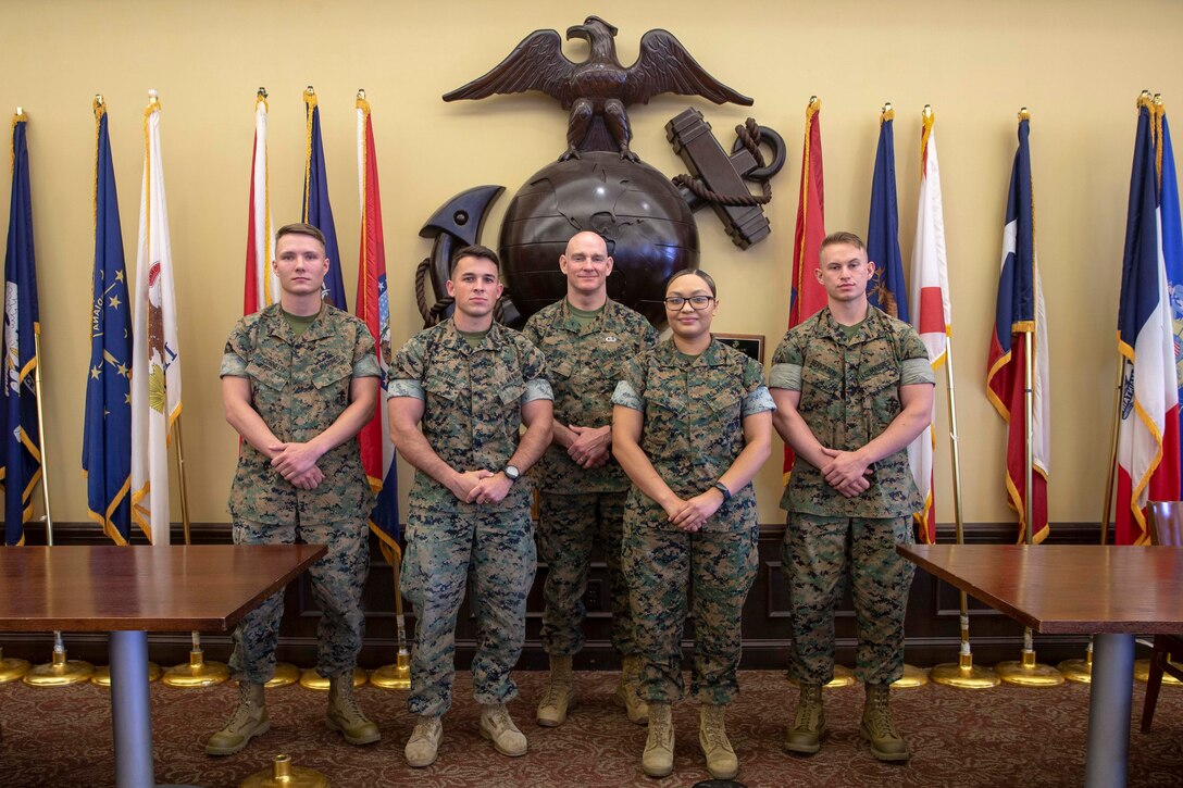 The 19th Sergeant Major of the Marine Corps, Sgt. Maj. Troy E. Black, poses for a photo with Marines selected for their outstanding performance at The Basic School (TBS), Triangle, Va, June 3, 2021. The Sergeant Major of the Marine Corps spoke to the Marines that man the supporting establishment at TBS and toured their work sections. The supporting units ensure that Marine Corps officers training at TBS are taught the basics skills to effectively lead as a Marine Officer. (U.S. Marine Corps photo by Sgt. Victoria Ross)