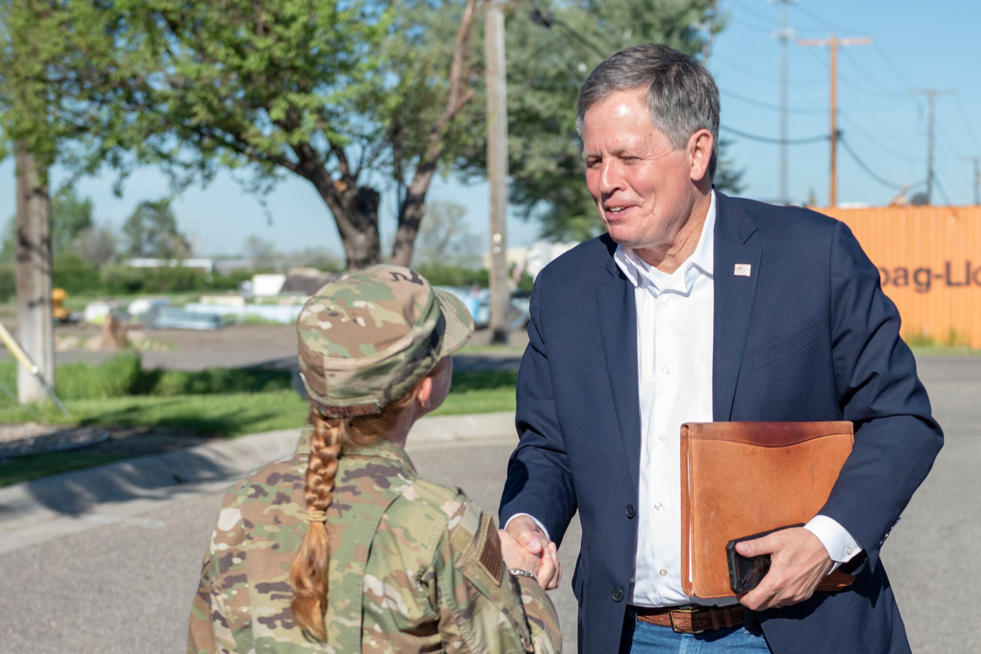 Sen. Steve Daines, right, greets Col. Anita Feugate Opperman, 341st Missile Wing commander, June 3, 2021, at his arrival to Malmstrom Air Force Base, Mont.