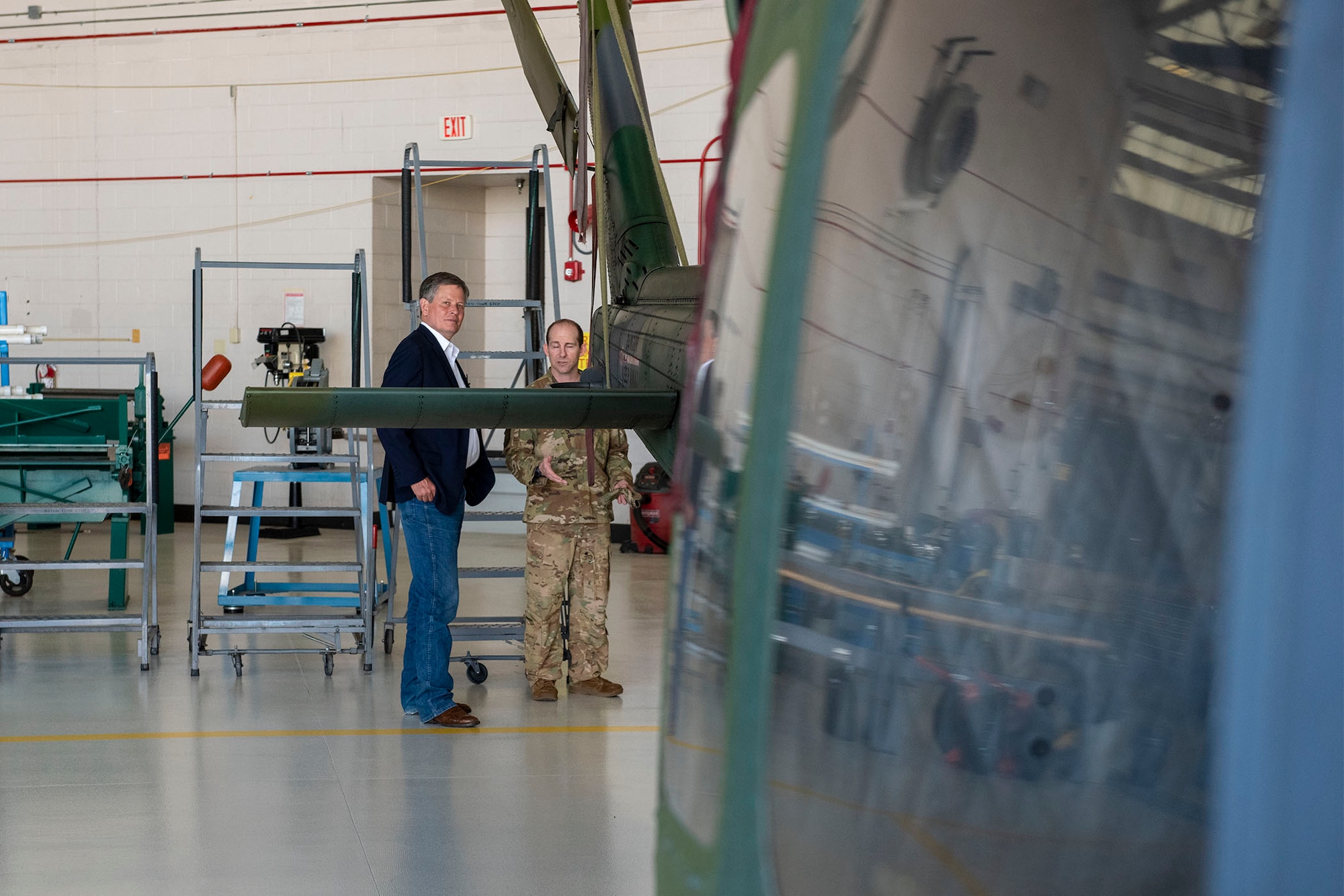 Sen. Steve Daines, left, speaks with Lt. Col. Kevin Weaver, 40th Helicopter Squadron commander, June 3, 2021, during his trip to Malmstrom Air Force Base, Mont.