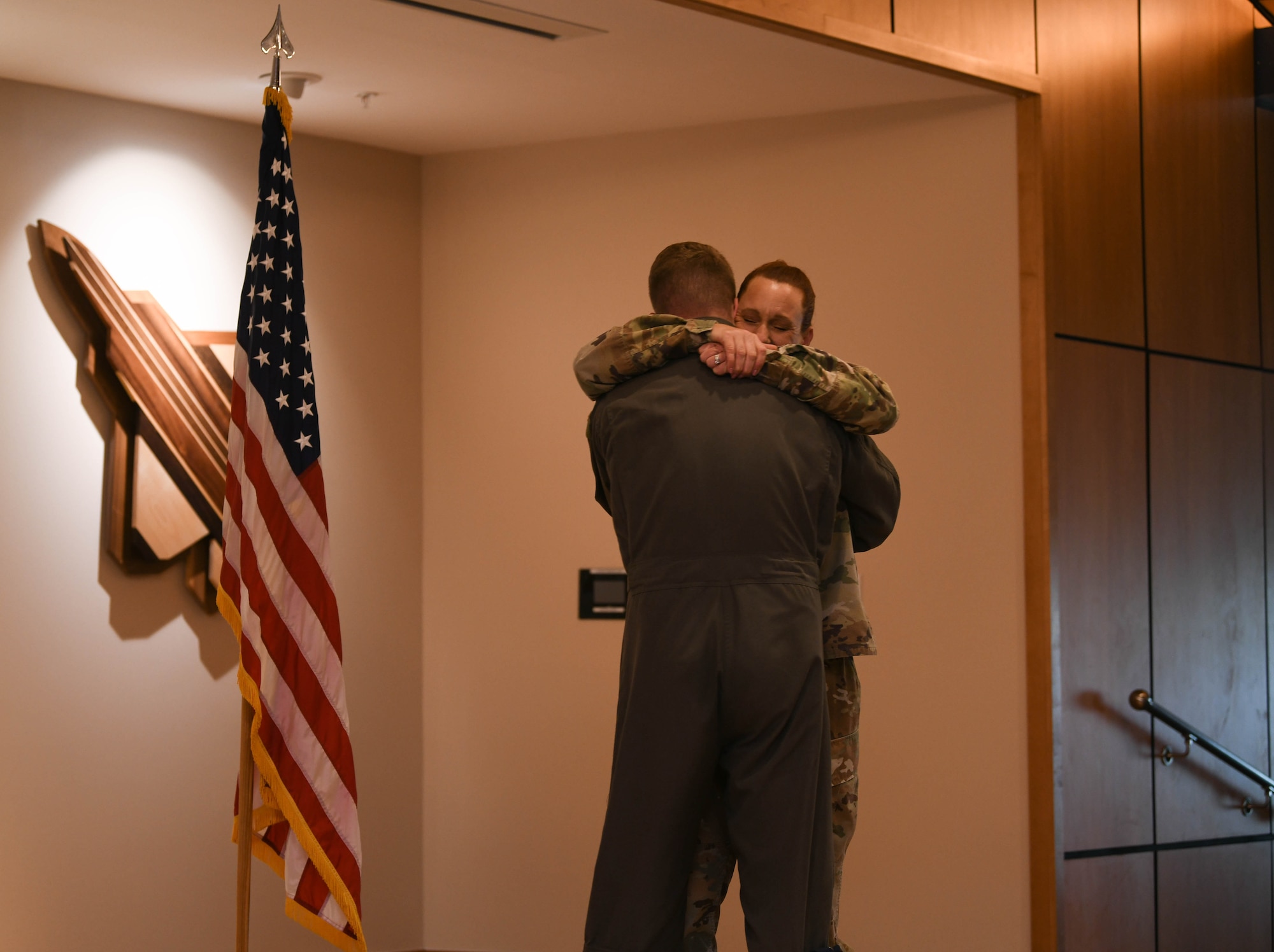 Grabham embraces Garcia after conducting the oath of enlistment
