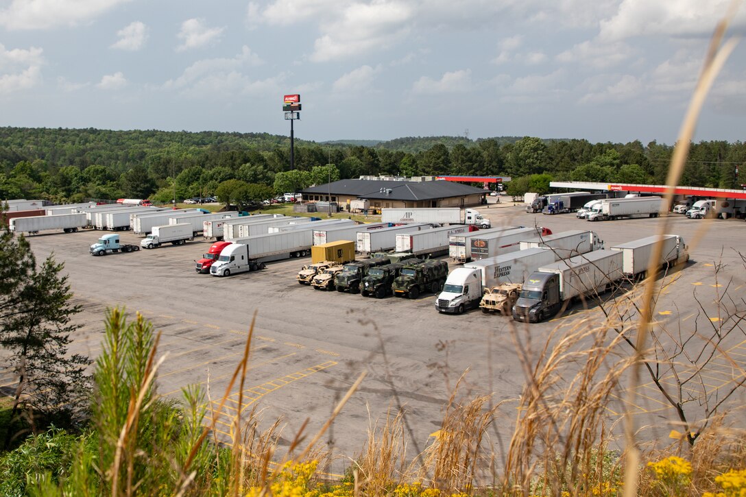 U.S. Marines stage vehicles at a truck stop near Tuscaloosa, Alabama, May 3, 2021. Marines with 2nd Transportation Battalion, Combat Logistics Regiment 2, 2nd Marine Logistics Group conducted a convoy across the United States starting in Camp Lejeune, North Carolina and arriving at Marine Corps Air Ground Combat Center Twentynine Palms, California, in on of the longest convoys in recent Marine Corps history. (U.S. Marine Corps photo by Lance Cpl. Scott Jenkins)