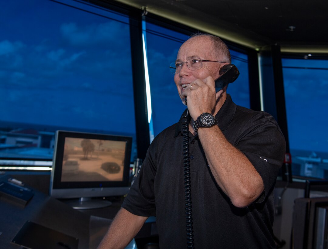 Donald Beckwith, 45th Logistics Readiness Squadron lead air traffic controller, demonstrates how he would contact the Orlando International Airport tower from inside the Patrick Space Force Base, Fla., tower May 18, 2021. Beckwith lead operations in the tower April 17 when a TBM Avenger made an emergency water landing near Patrick SFB. (U.S. Space Force photo by Tech. Sgt. James Hodgman)