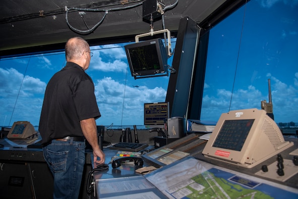 Donald Beckwith, 45th Logistics Readiness Squadron lead air traffic controller, watches a UH-60 Black Hawk helicopter fly over the airfield from inside the Patrick Space Force Base, Fla., tower May 18, 2021. Beckwith lead operations in the tower April 17 when a TBM Avenger made an emergency water landing near Patrick SFB. (U.S. Space Force photo by Tech. Sgt. James Hodgman)
