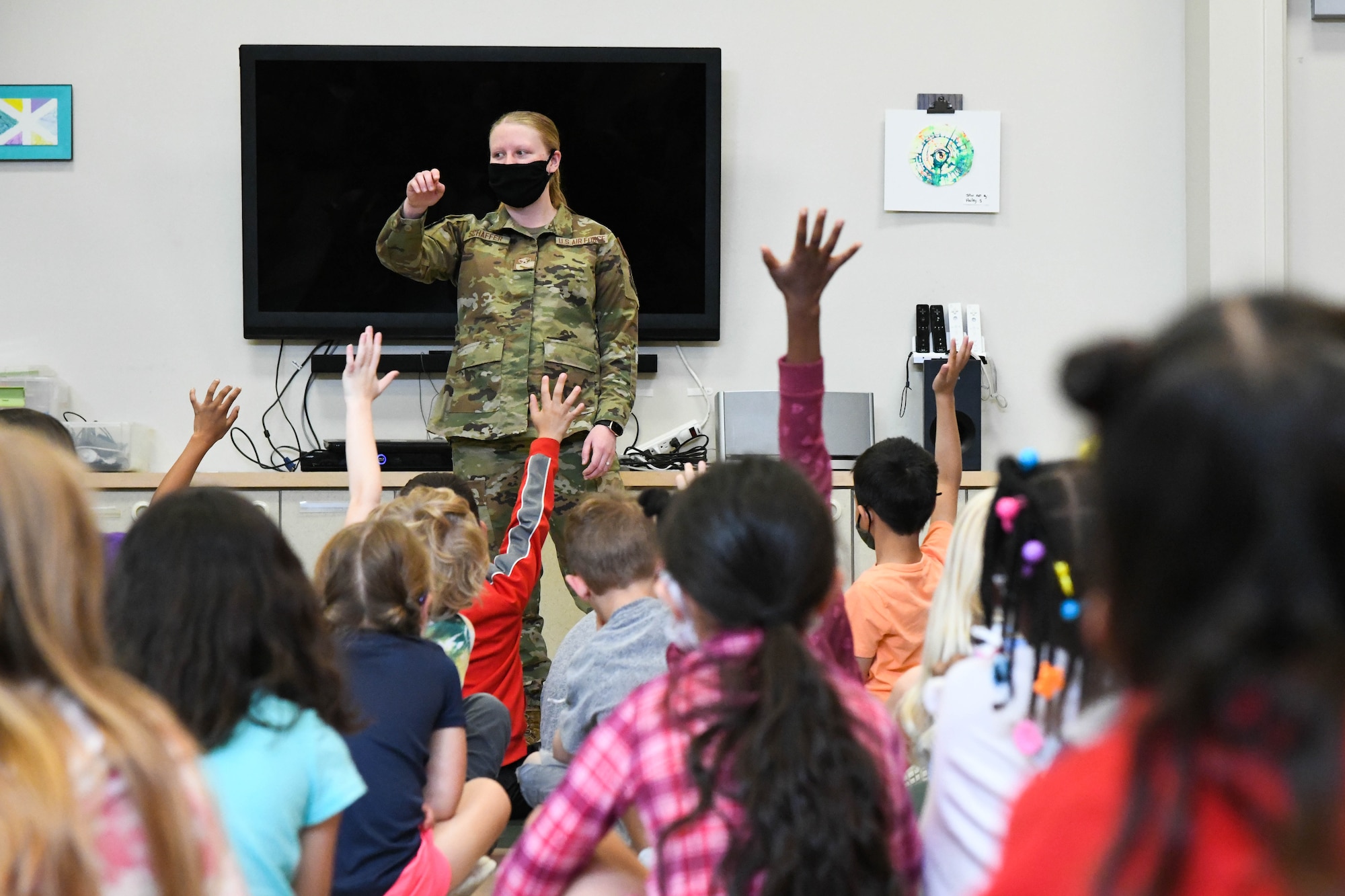 Airman 1st Class Kirsten Schaffer, 22nd Civil Engineer Squadron emergency management journeyman, briefs children at McConnell’s School Age Program about earthquake safety June 2, 2021, at McConnell Air Force Base, Kansas. McConnell’s SAP provides fun and educational all-day care during the summer months to military children between the ages of 5 and 12. (U.S. Air Force photo by Senior Airman Nilsa Garcia)