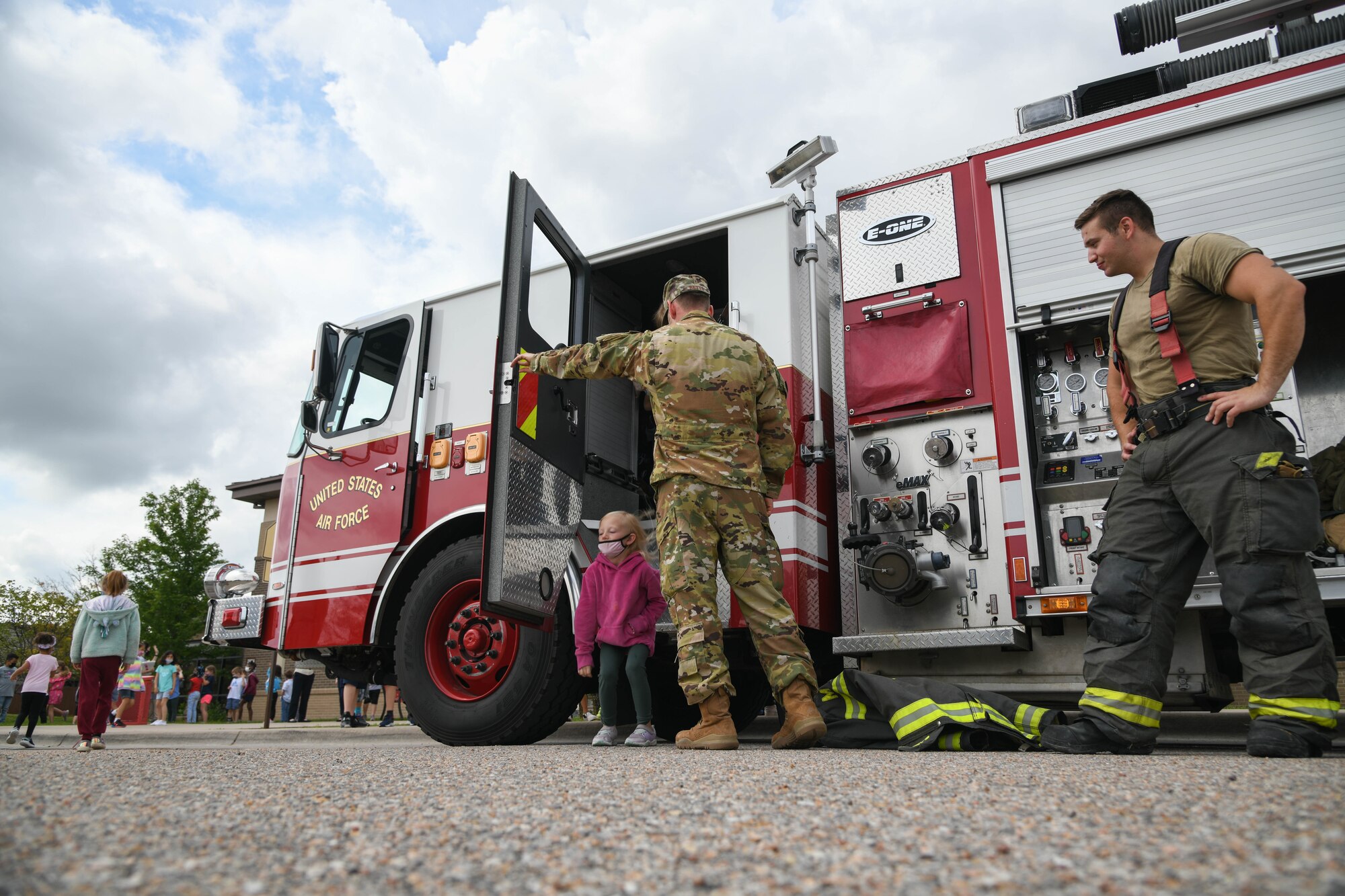 Children tour the interior of a fire truck June 2, 2021, at McConnell Air Force Base, Kansas. Each year Airmen from McConnell’s fire station 1 visit the School Age Program to educate youths about fire safety and what actions to take in case of an emergency. (U.S. Air Force photo by Senior Airman Nilsa Garcia)