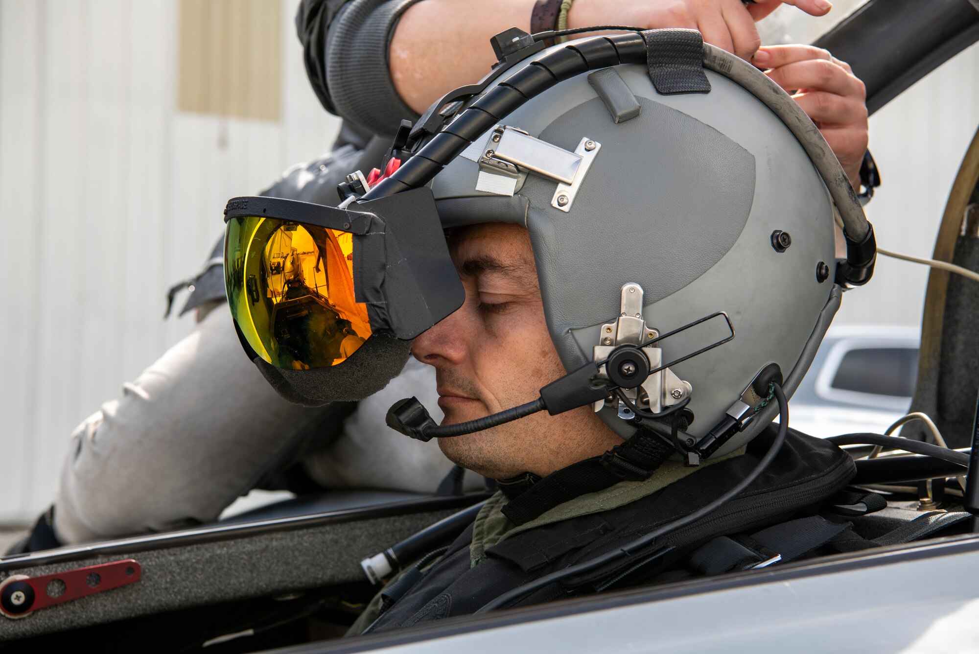 U.S. Air Force Maj. Scott Thorup, Air Combat Command Training Support Squadron Detachment 14 commander, prepares for takeoff as Rina Shkrabova, Red 6 director of hardware design, connects the augmented reality headset to the Berkut in Santa Monica, Calif., April 13, 2021.