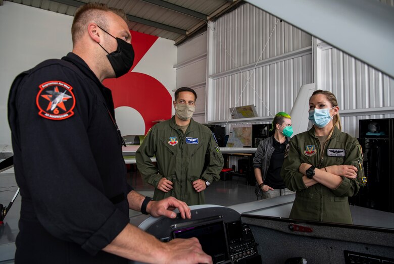 Glenn Snyder, Red 6 hardware developer, left, speaks with U.S. Air Force personnel in Santa Monica, Calif., April 13, 2021.