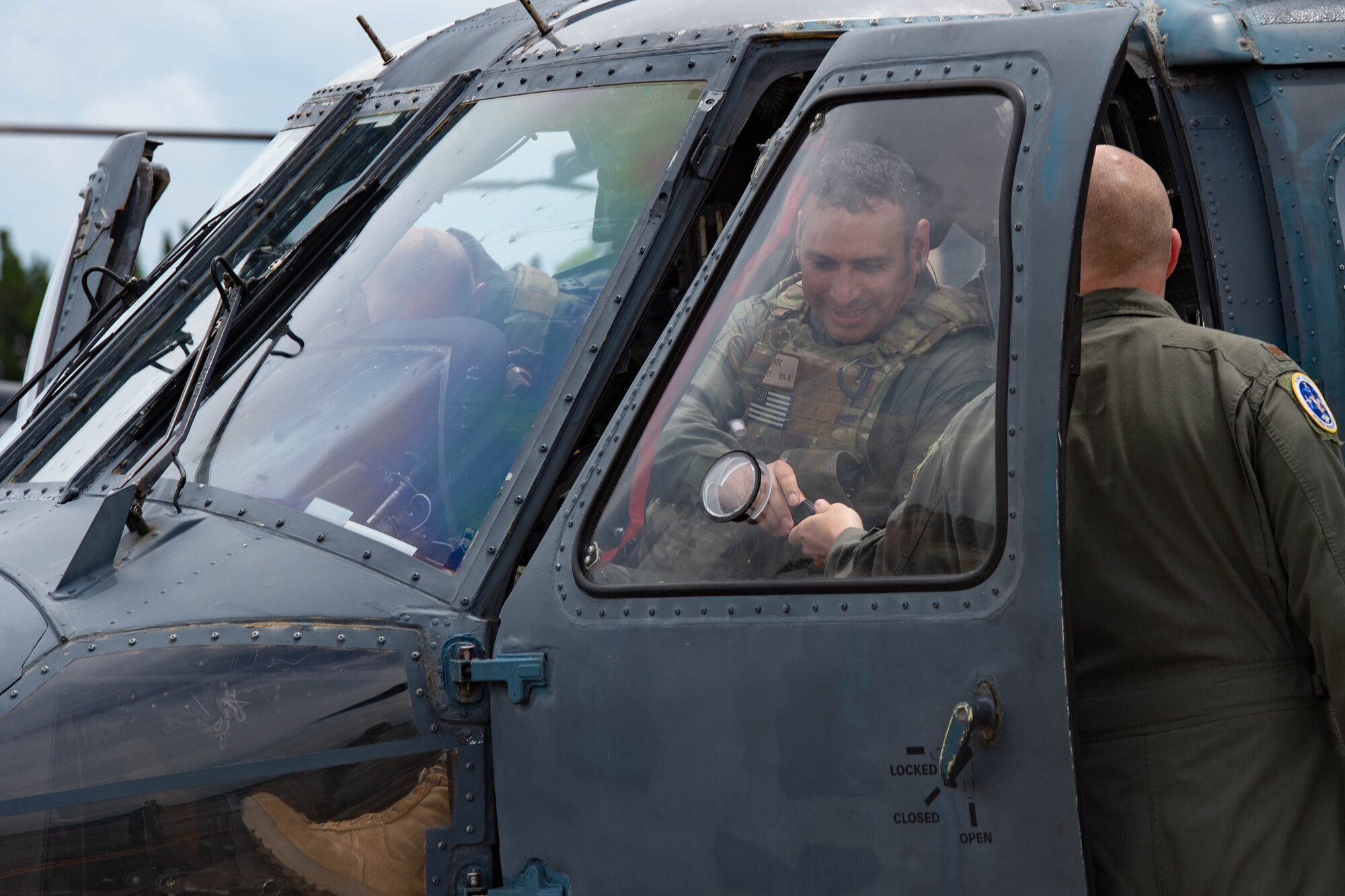 A photo of an Airman getting out of a helicopter.
