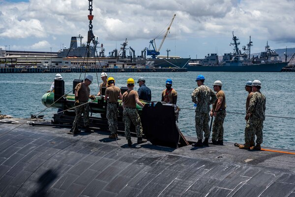 Sailors assigned to the Los Angeles-class fast-attack submarine USS Columbia (SSN 771) load a Mark 48 advanced capability torpedo for Exercise Agile Dagger 2021 (AD21).