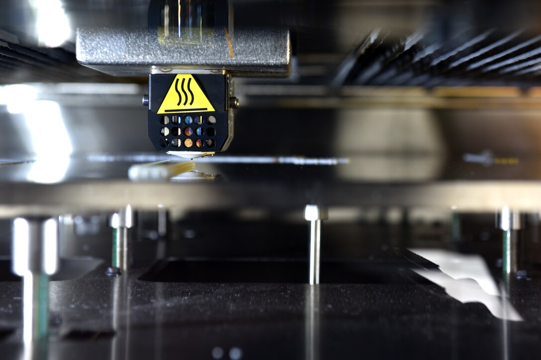 Airmen assigned to the 911th Maintenance Squadron fabrication flight use a new 3D printer to create a test part for the C-17 Globemaster III at the Pittsburgh International Airport Air Reserve Station, May 10, 2021.